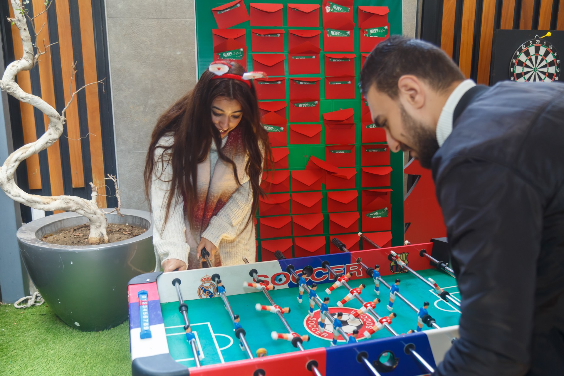 Colleagues playing table football during ATRIC's holiday fun day