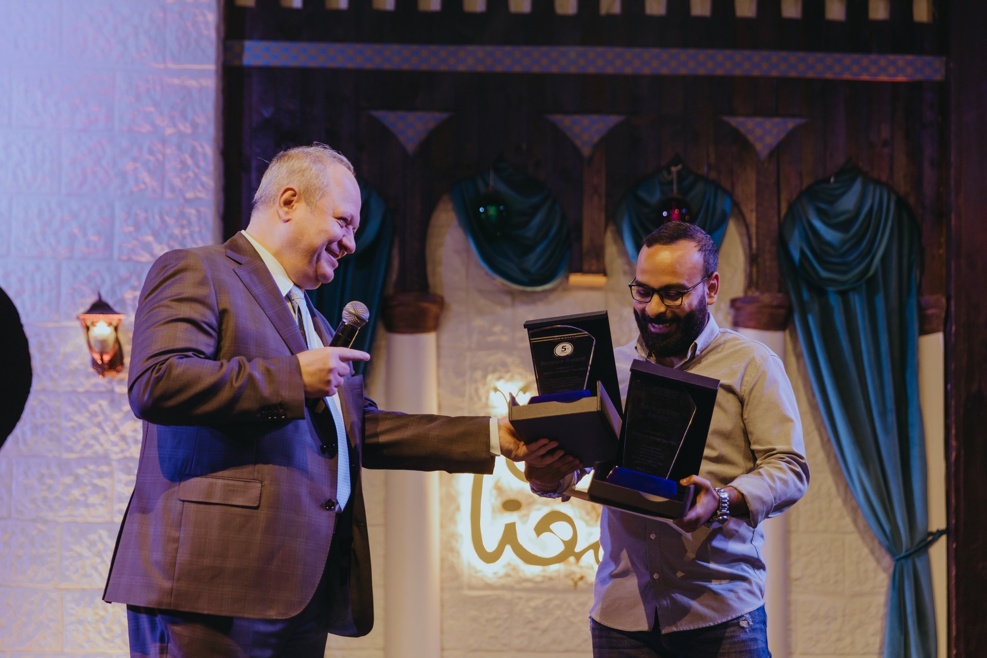 A colleague being recognised during the ATRIC team Iftar