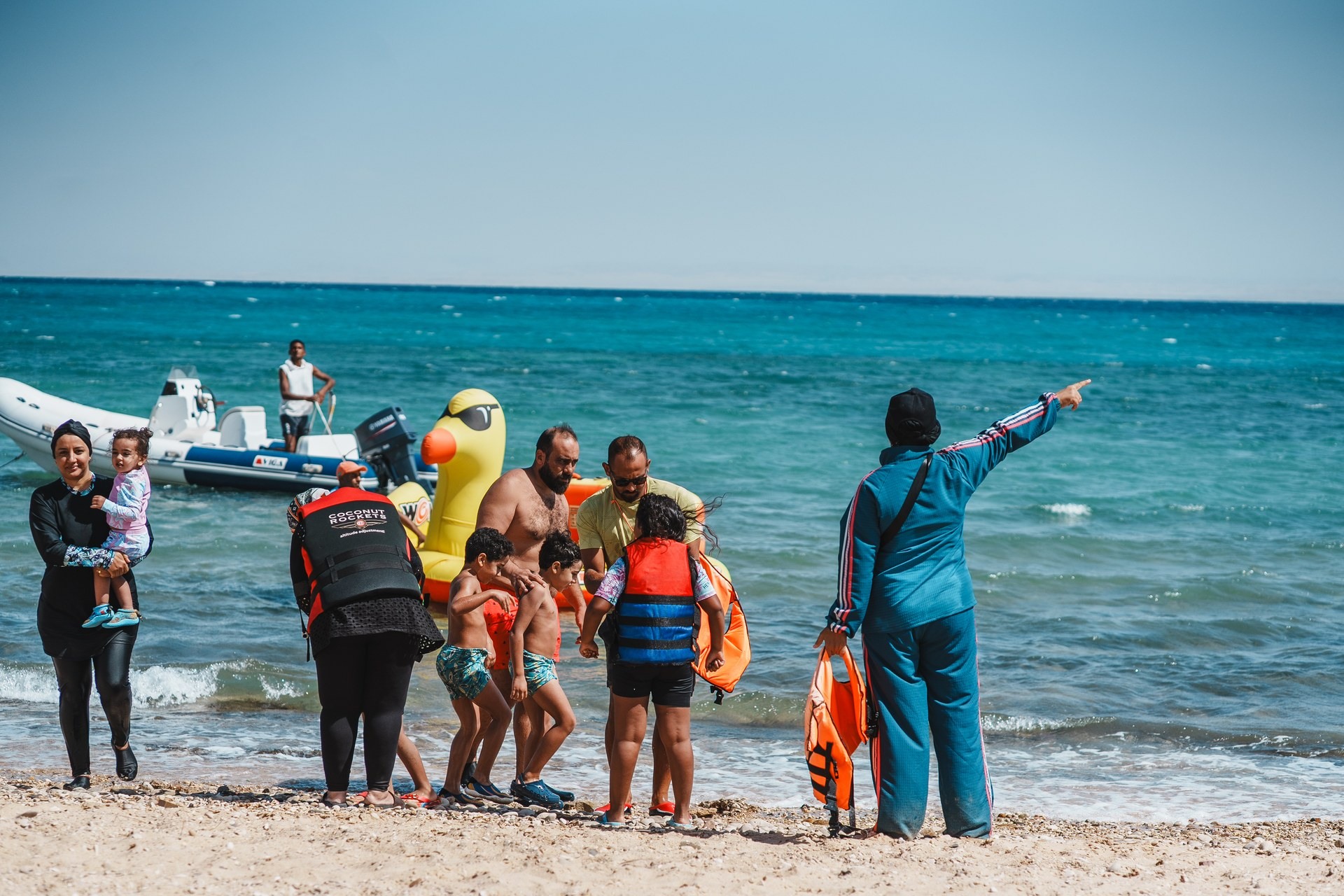 BOHO community members in life jackets at the Red Sea shoreline
