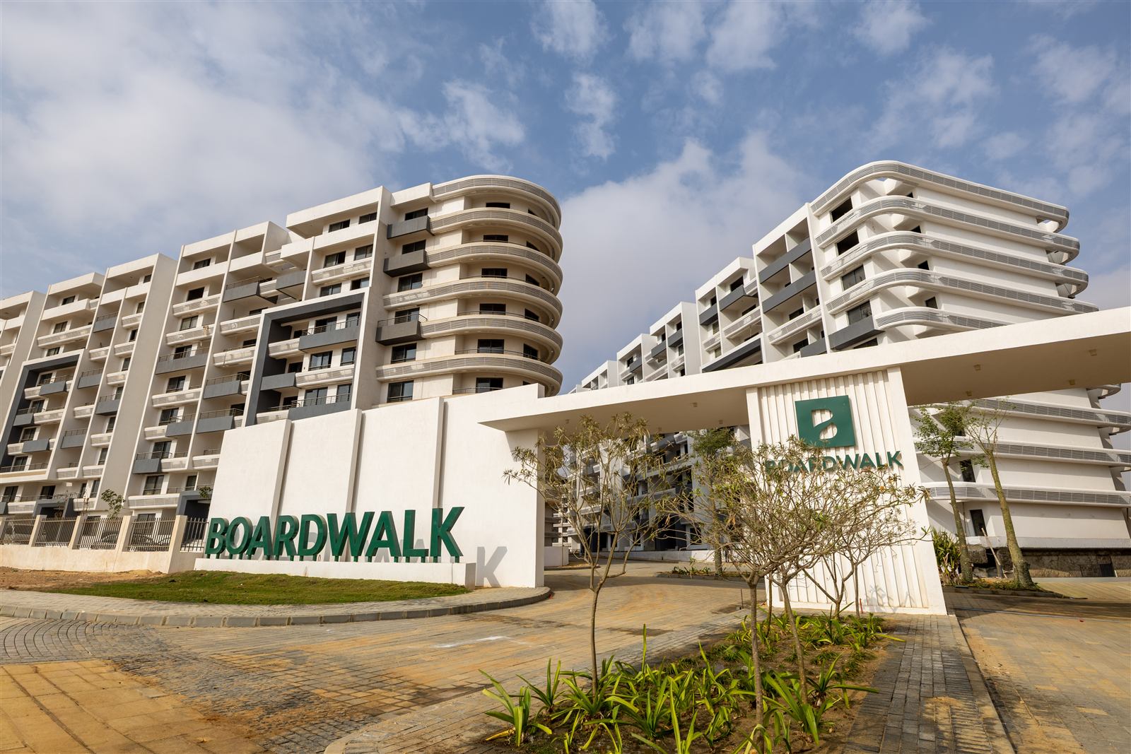 Boardwalk entrance with completed Zone C buildings in November 2025